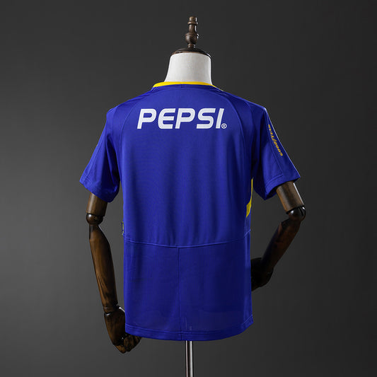 Camiseta retro Boca Juniors 2003/04 primera equipación detalle escudo La Bombonera – Cortita y al Pie