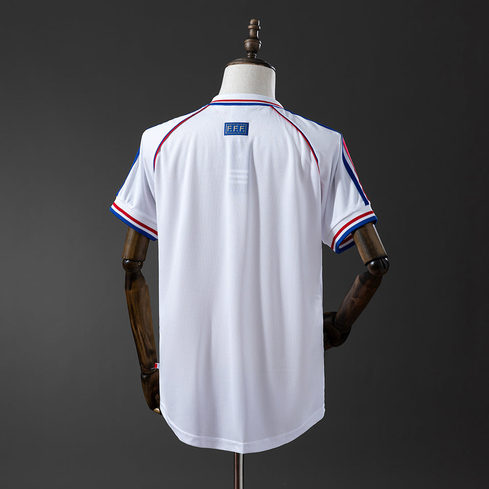 Camiseta retro Francia 1998 segunda equipación blanca detalle escudo – Cortita y al Pie
